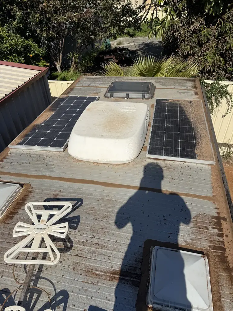 Caravan roof before cleaning, dirty solar panels and rust streaks, Perth